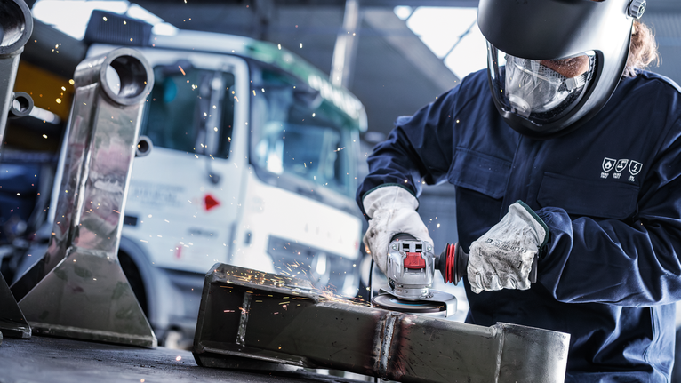 Người đeo thiết bị an toàn mài kim loại, tạo ra tia lửa.