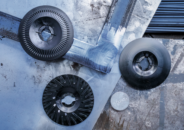 Ba đĩa mài và cắt kim loại được sắp xếp trên bề mặt kim loại bị trầy xước.