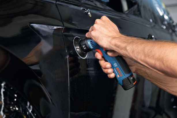 GEX 12V-77 Một người sử dụng máy chà nhám quỹ đạo ngẫu nhiên để đánh bóng bề mặt cửa ô tô.